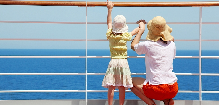 Mother and child looking out to sea from a cruise ship.