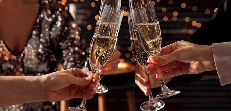 People clinking champagne glasses at Christmas